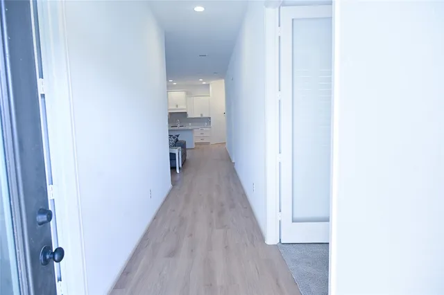 a view of a room with wooden floor and a bathroom