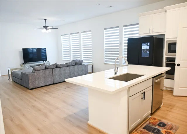 a kitchen with a sink and a stove top oven