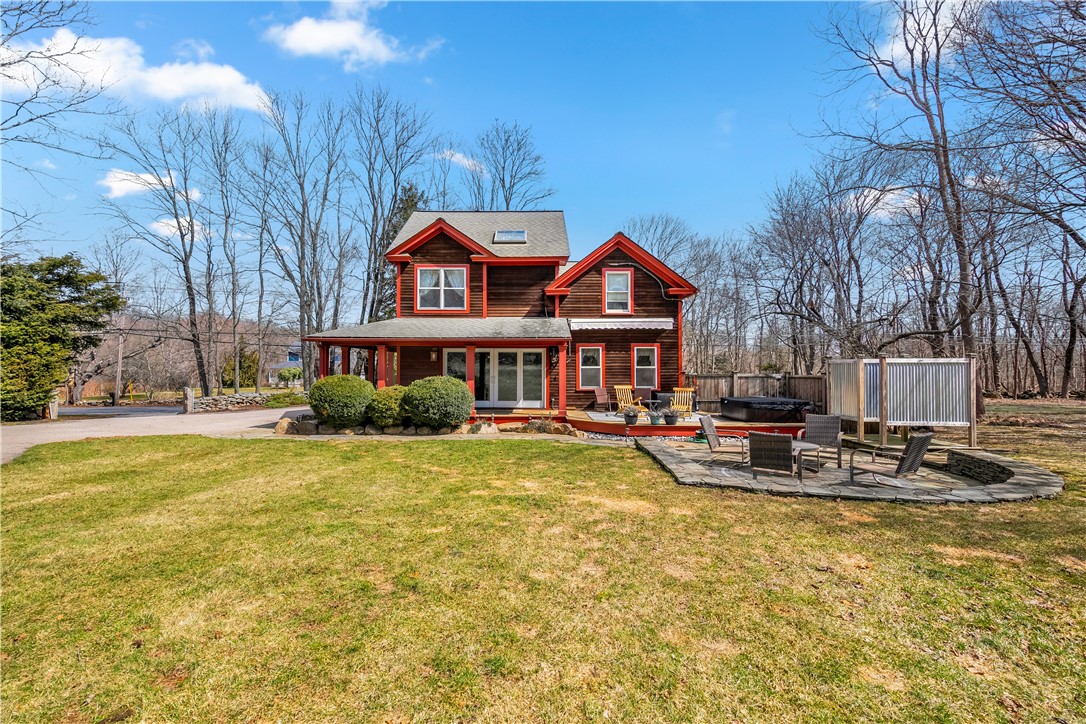 613 Slocum Road Exeter, RI 02874 - Photo 7 of 43 View of house from the backyard. Note the stone walkway and patio, wrap-around deck, and outdoor shower with hot water!
