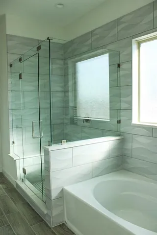 a bathroom with a bathtub and shower