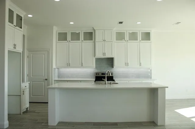 a kitchen with a sink and a refrigerator
