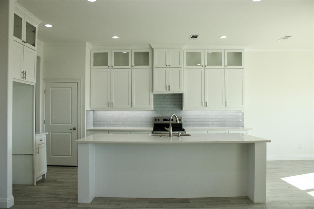 102 Country Road 4511 Decatur, TX 76234 - Photo 3 of 34 a kitchen with a sink and a refrigerator