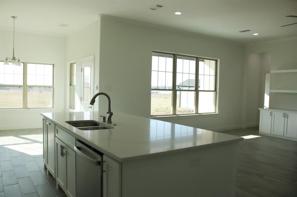 102 Country Road 4511 Decatur, TX 76234 - Photo 4 of 34 a kitchen with granite countertop a sink and a stove