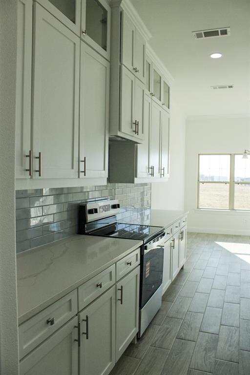 102 Country Road 4511 Decatur, TX 76234 - Photo 5 of 34 a kitchen with stainless steel appliances granite countertop a sink a stove and cabinets