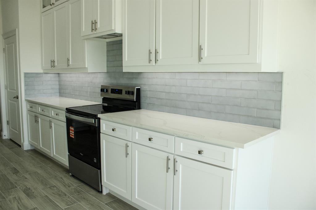 102 Country Road 4511 Decatur, TX 76234 - Photo 6 of 34 a kitchen with white cabinets and white appliances