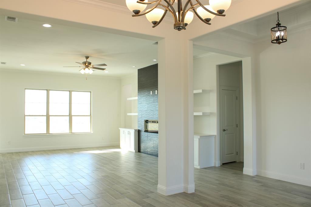 102 Country Road 4511 Decatur, TX 76234 - Photo 9 of 34 a view of an empty room with wooden floor and a window