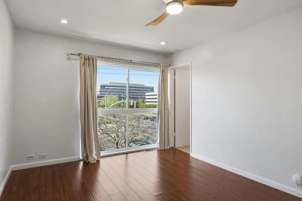 wooden floor in an empty room with a window