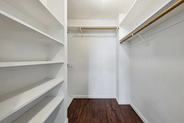 a view of walk in closet with empty racks