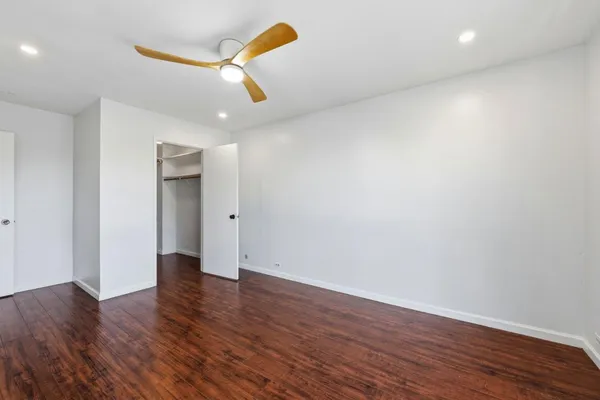 a view of an empty room with wooden floor