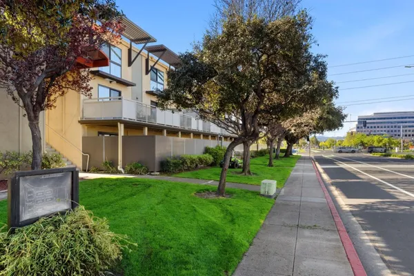 a view of street along with house and trees