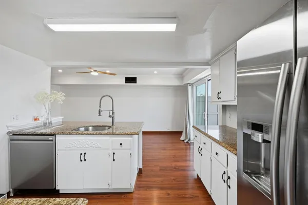 a spacious bathroom with a double vanity sink and mirror
