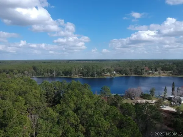 view of a lake with houses in the back