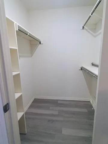 a bathroom with a granite countertop tub sink and mirror