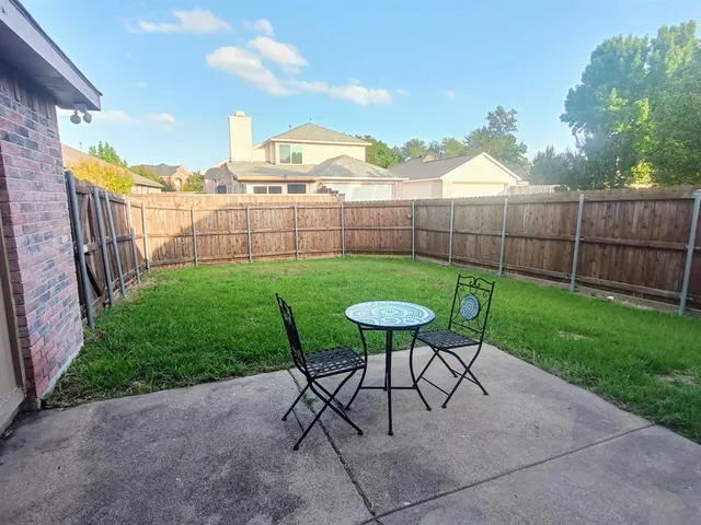 a view of a house with a yard and sitting area