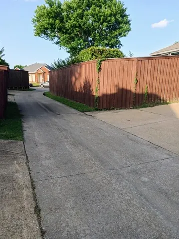 a view of a backyard with wooden fence