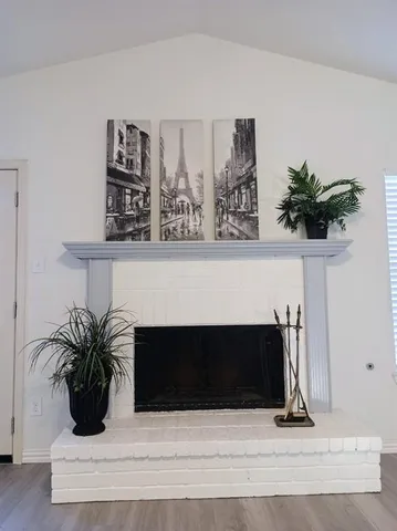 a view of living room with furniture and potted plant