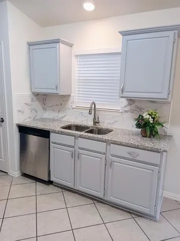 a kitchen with a sink and cabinets