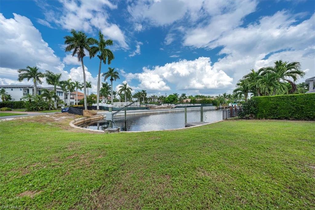 2001 Kingfish Road Naples, FL 34102 - Photo 16 of 24 a view of a lake with houses in the back