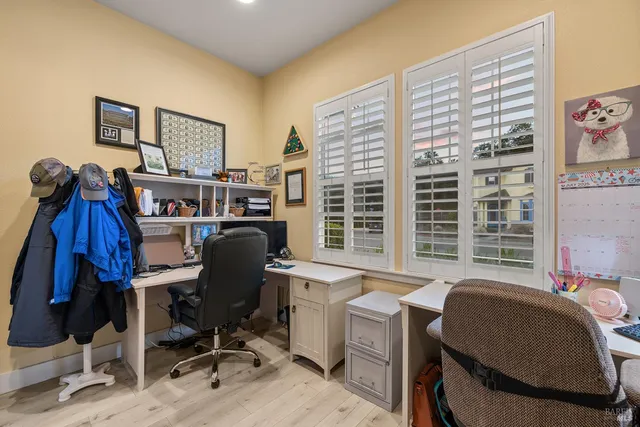 a dining room with furniture a rug and wooden floor