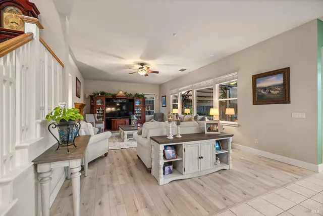 a kitchen with stainless steel appliances kitchen island granite countertop a table chairs and a refrigerator