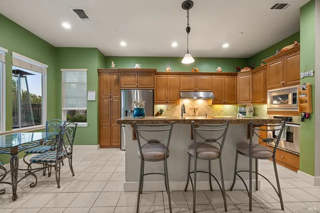 a bedroom with a bed flat screen tv and couches