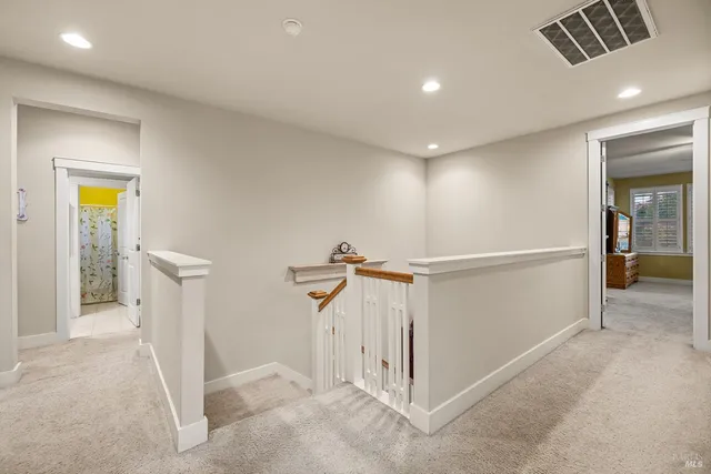 an aerial view of residential houses with outdoor space and trees