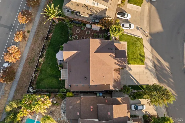 an aerial view of a house with a yard