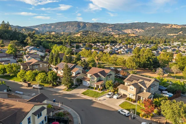 a view of a house with backyard and sitting area