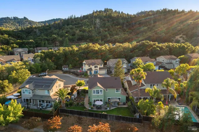 an aerial view of a house with a yard