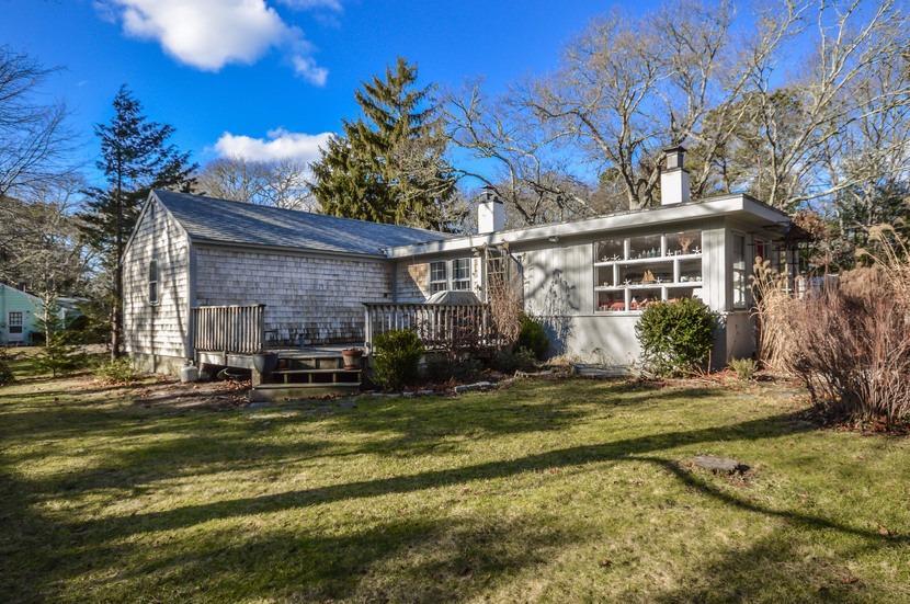 59 Lewis Pond Road Cotuit, MA 02635 - Photo 17 of 24 a view of a house with a yard patio and fire pit