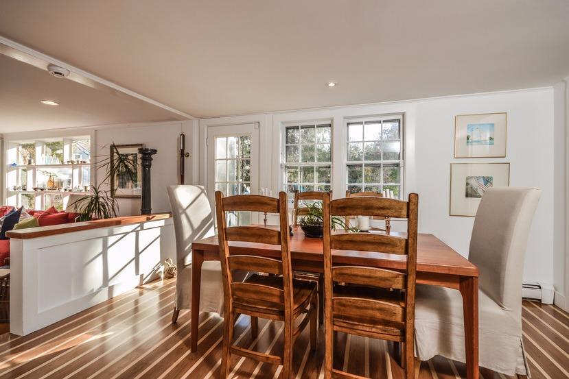 59 Lewis Pond Road Cotuit, MA 02635 - Photo 6 of 24 a view of a dining room with furniture a chandelier and wooden floor