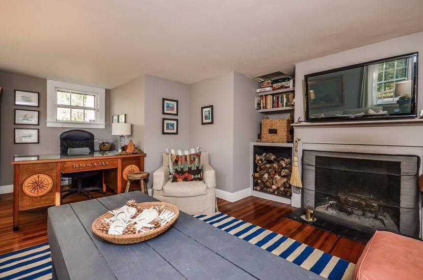 59 Lewis Pond Road Cotuit, MA 02635 - Photo 10 of 24 a living room with furniture a flat screen tv and a fireplace