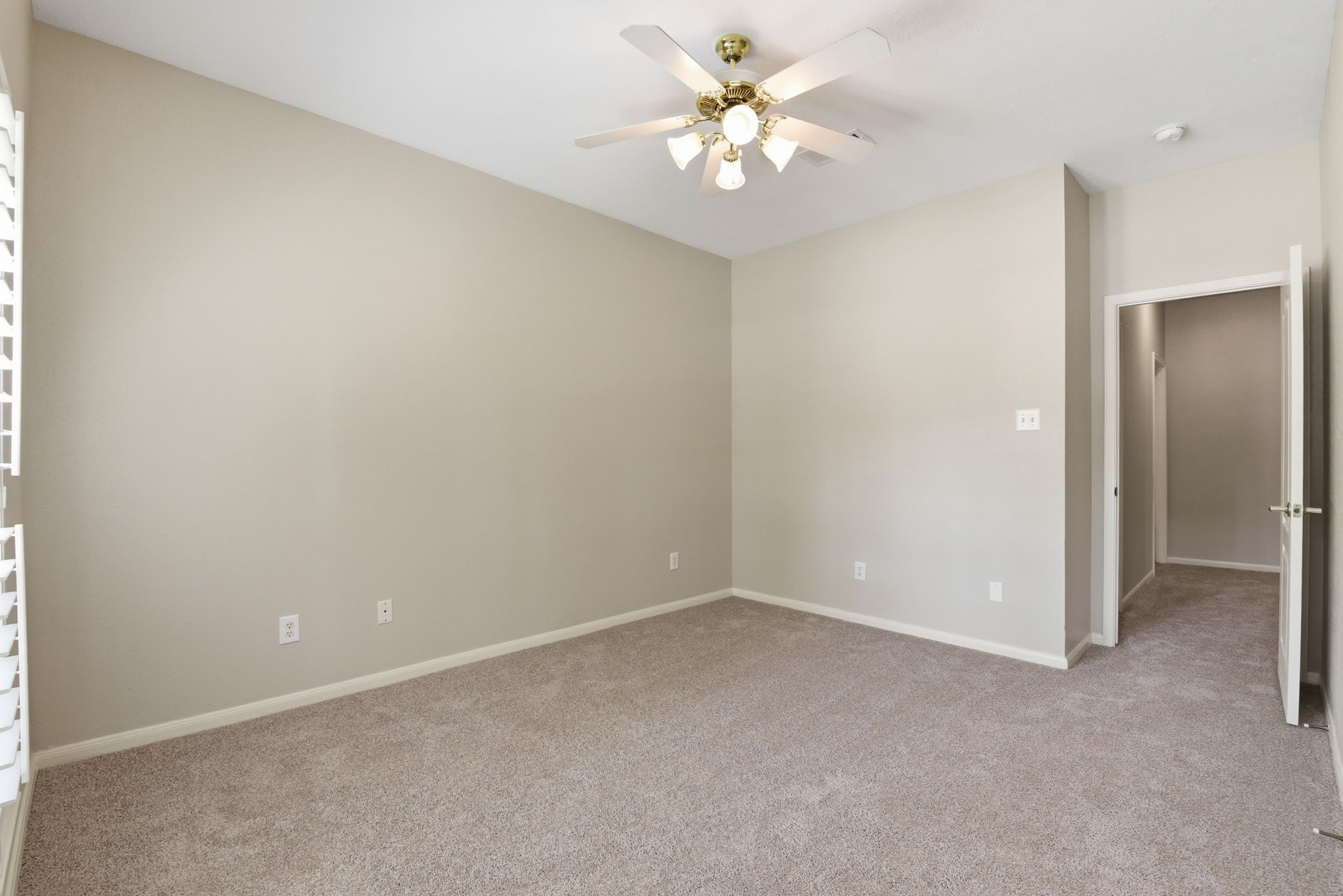3414 Hackberry Court Spring, TX 77388 - Photo 30 of 50 Secondary bedroom downstairs. Carpet replaced April 2026, fresh paint, ceiling fan, white wooden shutters!