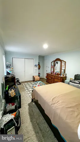 a bedroom with a bed and a dresser in it