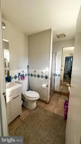 a bathroom with a toilet a sink and a mirror