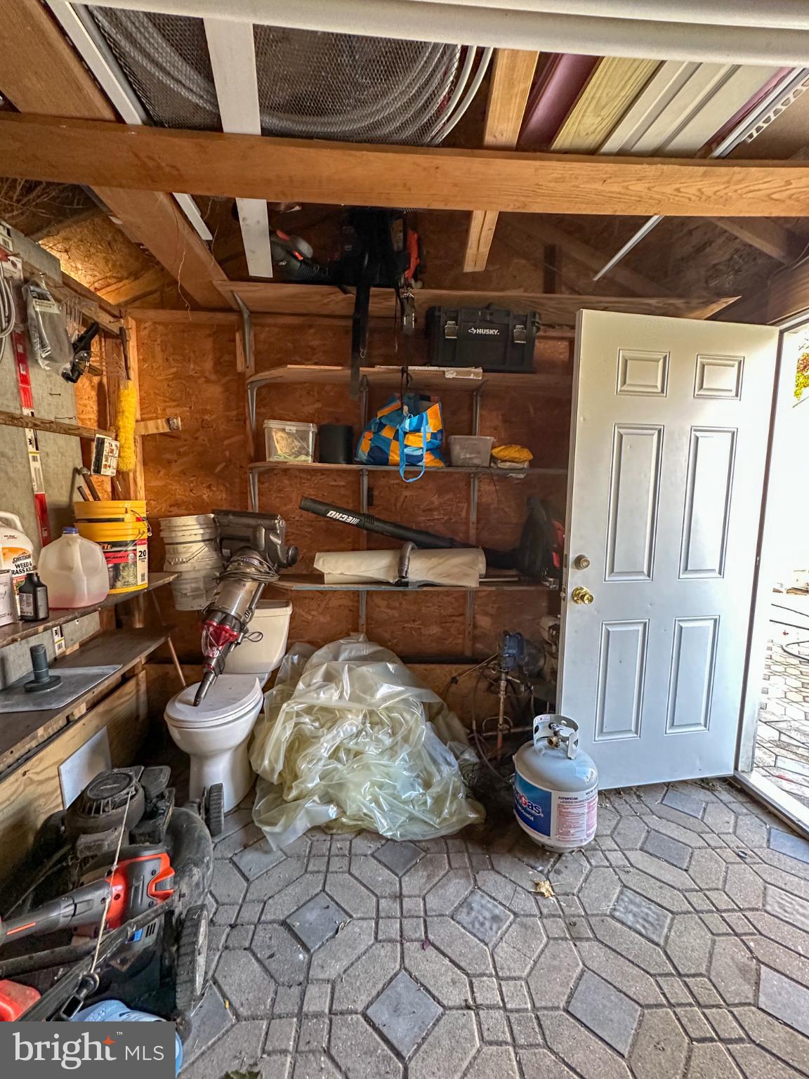 910 Magnolia Avenue Croydon, PA 19021 - Photo 29 of 33 Cluttered garage with tools and storage.