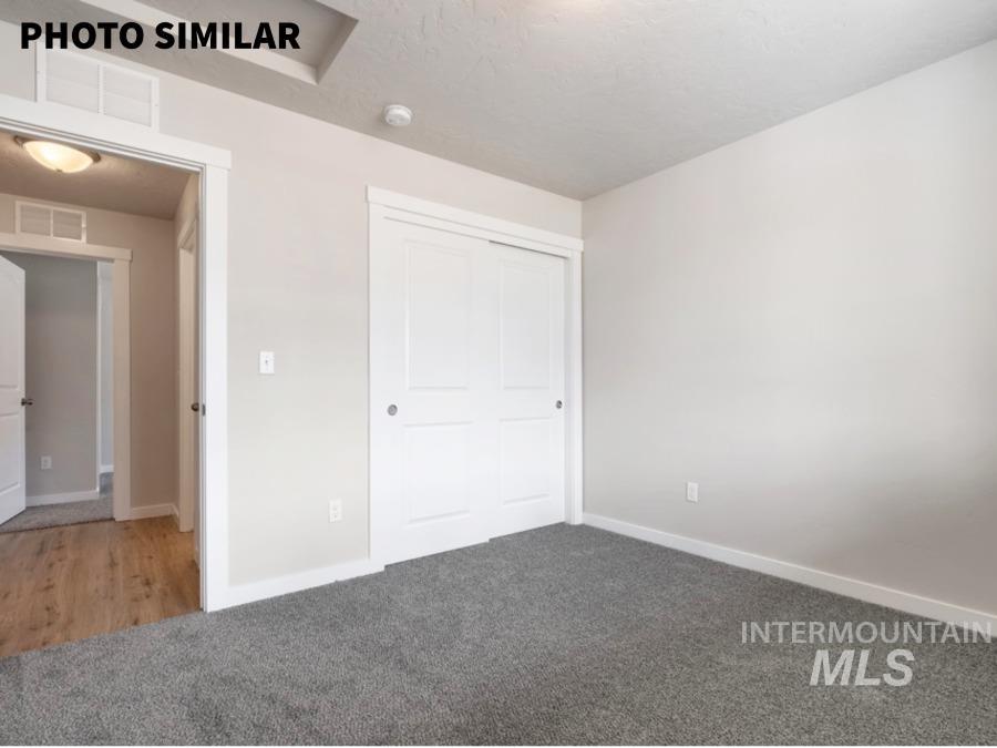 925 Twilight Weiser, ID 83672 - Photo 23 of 31 Spacious room featuring neutral wall paint, gray carpet flooring, and a double-door closet with white trim