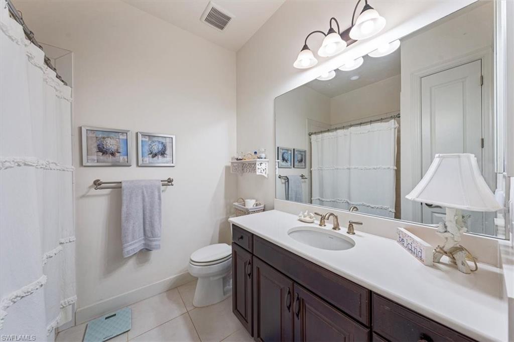 23734 Pebble Pointe Lane Estero, FL 34135 - Photo 17 of 34 a bathroom with a sink a toilet and a mirror