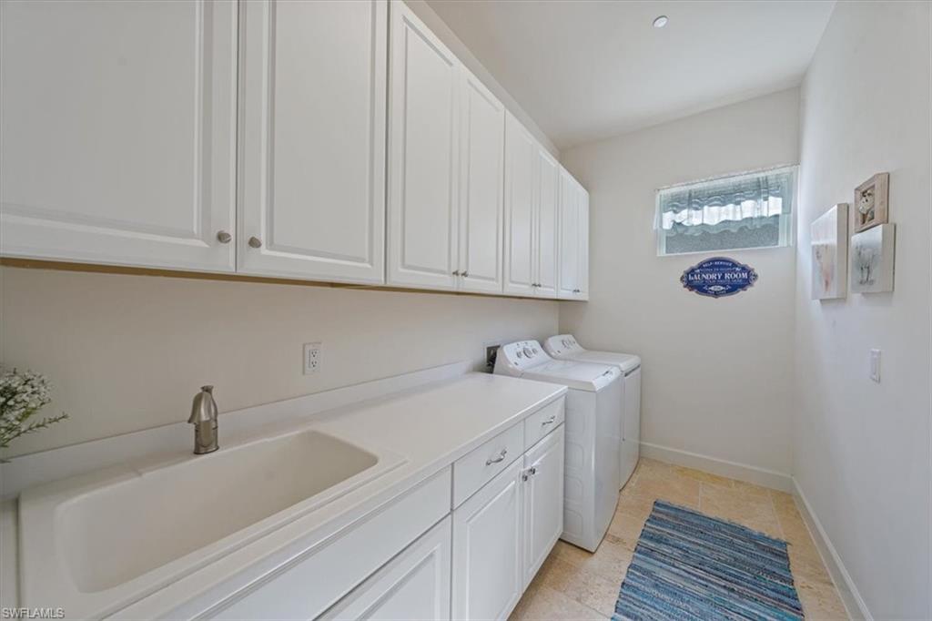 23734 Pebble Pointe Lane Estero, FL 34135 - Photo 18 of 34 a kitchen with a sink and cabinets