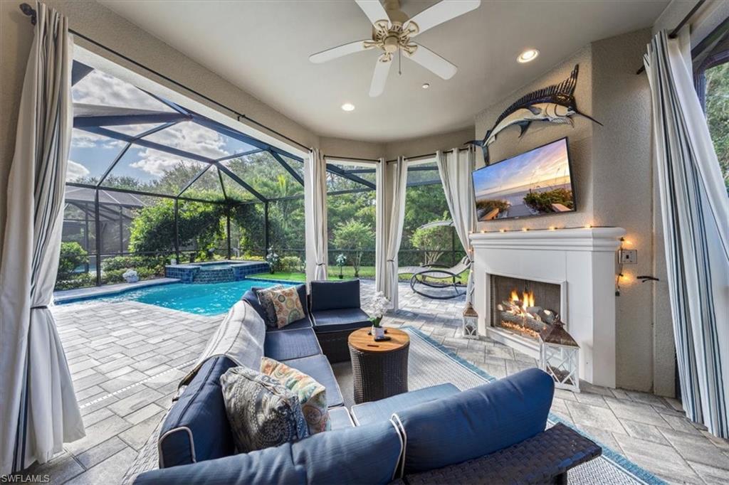 23734 Pebble Pointe Lane Estero, FL 34135 - Photo 21 of 34 a living room with furniture and a fireplace
