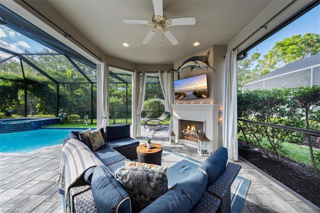 23734 Pebble Pointe Lane Estero, FL 34135 - Photo 22 of 34 a living room with fireplace furniture and a garden