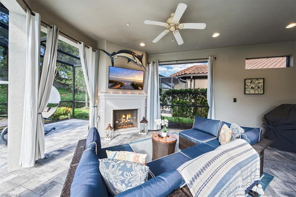 23734 Pebble Pointe Lane Estero, FL 34135 - Photo 23 of 34 a living room with furniture fireplace and a large window