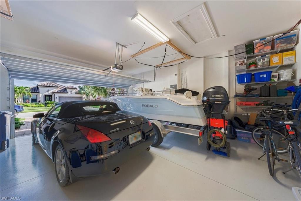 23734 Pebble Pointe Lane Estero, FL 34135 - Photo 30 of 34 a view of a garage with parked cars