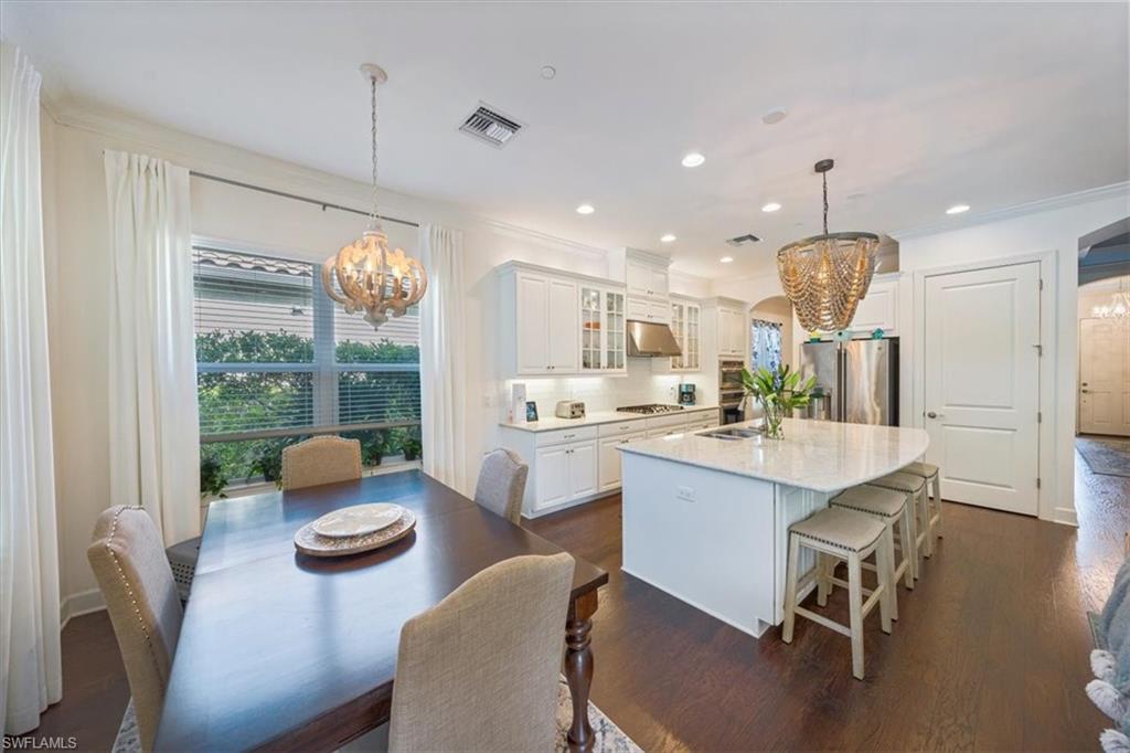 23734 Pebble Pointe Lane Estero, FL 34135 - Photo 6 of 34 a large kitchen with a table and chairs in it