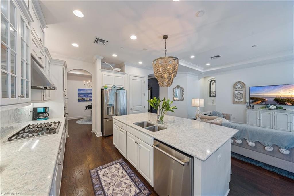 23734 Pebble Pointe Lane Estero, FL 34135 - Photo 8 of 34 a kitchen with stainless steel appliances granite countertop a sink and a refrigerator