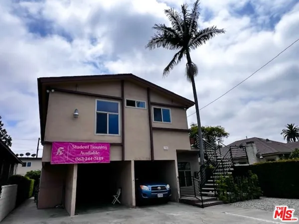 a front view of a house with parking space