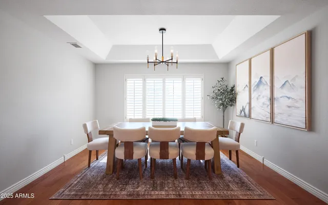 a view of a a dining room with furniture window and wooden floor