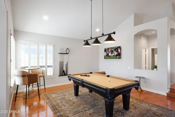 a room with furniture pool table and windows
