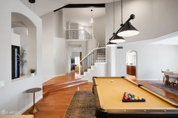 a living room with table tennis and stairs