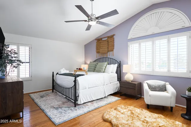 a bedroom with furniture and a large window